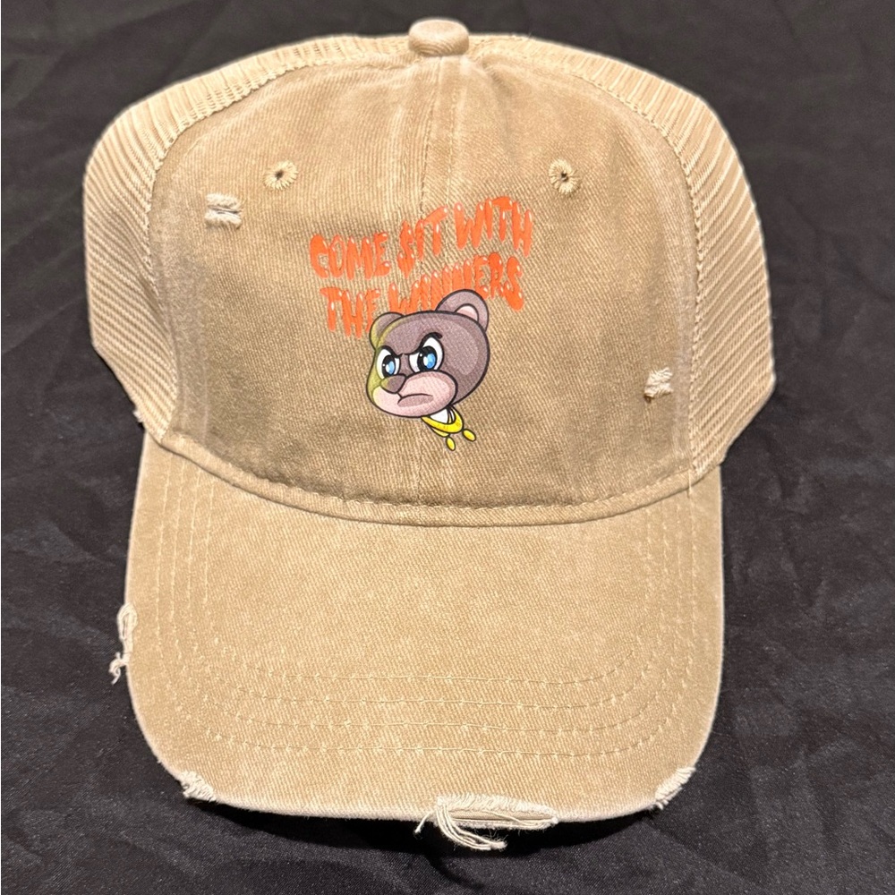 Tan distressed Cap with stylish bear and orange graphic logo design.